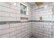 A tile shower with a window, niche and gold shower head at 4131 West Village Pkwy, Ellenwood, GA 30294
