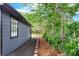 Side view of a home featuring a well-manicured yard with brick path at 4131 West Village Pkwy, Ellenwood, GA 30294