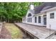 Spacious wooden deck adjoins the home's exterior and overlooks the backyard with wooded views at 7240 Highbrook Cir, Cumming, GA 30041