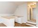 Attic conversion to bonus space with a wet bar, mini fridge, and access to additional room via stairs at 7240 Highbrook Cir, Cumming, GA 30041