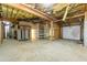 Unfinished basement space with utilities and garage access, offering ample storage and workshop potential at 7240 Highbrook Cir, Cumming, GA 30041