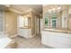 Bright bathroom with double vanities, tile floors, and soaking tub at 7240 Highbrook Cir, Cumming, GA 30041