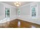 Formal dining room features wainscoting, hardwood floors, and chandelier at 7240 Highbrook Cir, Cumming, GA 30041