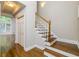 Bright entryway with hardwood floors, a staircase, and a closet at 7240 Highbrook Cir, Cumming, GA 30041
