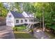 Charming two-story home with a porch, an attached garage, and a manicured yard at 7240 Highbrook Cir, Cumming, GA 30041