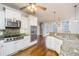 Gourmet kitchen with white cabinets, stainless appliances, granite counters and hardwood floors at 7240 Highbrook Cir, Cumming, GA 30041