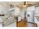 Bright kitchen features granite countertops, stainless steel appliances, and hardwood flooring at 7240 Highbrook Cir, Cumming, GA 30041