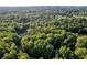 This aerial shows the property lines and a neighborhood of homes nestled amongst the trees at 7240 Highbrook Cir, Cumming, GA 30041