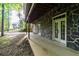 A covered walkway with stone siding provides easy access to the backyard and house at 7240 Highbrook Cir, Cumming, GA 30041