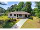 An aerial view of a well-maintained home with a manicured lawn and mature trees at 10116 Straphinge Trl, Covington, GA 30014