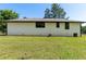 Spacious backyard featuring a lush green lawn and brick exterior of the home at 10116 Straphinge Trl, Covington, GA 30014