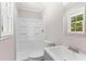 Bathroom features a step-in shower, vanity sink, and a window for natural light at 10116 Straphinge Trl, Covington, GA 30014