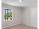 Cozy bedroom with large window offering natural light and carpet floors at 10116 Straphinge Trl, Covington, GA 30014