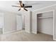 Bedroom showcasing neutral carpeting, a spacious closet, and connecting door to the bathroom at 10116 Straphinge Trl, Covington, GA 30014