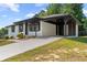 Charming single-story home showcasing a white brick exterior, dark trim and a well-manicured front yard at 10116 Straphinge Trl, Covington, GA 30014