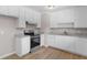 Well-equipped kitchen featuring white cabinets, modern appliances, and granite countertops at 10116 Straphinge Trl, Covington, GA 30014