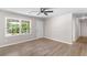 Inviting living room with large windows and hardwood floors with neutral colored walls at 10116 Straphinge Trl, Covington, GA 30014