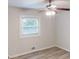 Bedroom with neutral walls, wood-look flooring, ceiling fan, and window with blinds at 3512 Valley Chase Ct, Lithonia, GA 30038