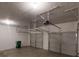 Spacious two car garage featuring two garage doors, ample lighting, and a recycling bin at 3512 Valley Chase Ct, Lithonia, GA 30038