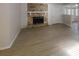 Spacious living room featuring a stone fireplace, light wood floors, and ample natural light at 3512 Valley Chase Ct, Lithonia, GA 30038