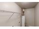 Compact utility room featuring a water heater, wall-mounted shelving, and laundry hook ups at 3512 Valley Chase Ct, Lithonia, GA 30038