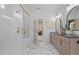 Bright bathroom featuring double vanity sinks, a walk-in shower, and elegant finishes at 4775 Wyat Farm Overlook, Cumming, GA 30040