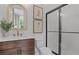 Modern bathroom featuring a glass-enclosed shower, decorative mirror, and stylish vanity at 4775 Wyat Farm Overlook, Cumming, GA 30040