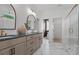 Modern bathroom with double vanity sinks, stylish mirrors, and a glass-enclosed shower at 4775 Wyat Farm Overlook, Cumming, GA 30040