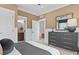 Serene bedroom with a view to a bathroom, calm color palette and sophisticated furnishings at 4775 Wyat Farm Overlook, Cumming, GA 30040