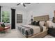 This comfortable bedroom showcases a well-made bed, music decor, and natural light from a large window at 4775 Wyat Farm Overlook, Cumming, GA 30040
