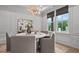Stylish dining room with a modern chandelier, round table, and large windows at 4775 Wyat Farm Overlook, Cumming, GA 30040