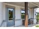 Charming covered porch with a bench, accent trim, professionally landscaped flower beds at 4775 Wyat Farm Overlook, Cumming, GA 30040