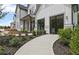 Inviting two-story home with lush landscaping and a curved walkway to the front door at 4775 Wyat Farm Overlook, Cumming, GA 30040
