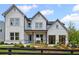 Charming two-story home featuring board and batten siding and a welcoming landscaped front yard at 4775 Wyat Farm Overlook, Cumming, GA 30040