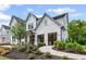 Newly constructed home showcasing modern farmhouse design, landscaping, and a welcoming walkway at 4775 Wyat Farm Overlook, Cumming, GA 30040