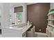 A stylish, functional home office with modern decor, natural light, and open shelving at 4775 Wyat Farm Overlook, Cumming, GA 30040