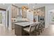 Well-lit kitchen island with seating, stainless steel appliances, and ample storage, blending style and practicality at 4775 Wyat Farm Overlook, Cumming, GA 30040