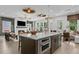Open kitchen island with stainless steel oven overlooking living area with fireplace and ample natural light at 4775 Wyat Farm Overlook, Cumming, GA 30040