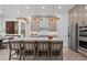Modern kitchen island with seating, stainless steel appliances, and stylish lighting, perfect for cooking and gathering at 4775 Wyat Farm Overlook, Cumming, GA 30040