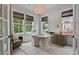 Well-lit home office featuring large windows, stylish light fixture, and a contemporary desk at 4775 Wyat Farm Overlook, Cumming, GA 30040