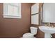 Modern powder room showcasing a pedestal sink, decorative art, and warm color palette at 4775 Wyat Farm Overlook, Cumming, GA 30040