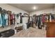 Walk-in closet featuring ample storage space with racks and shelves, providing organized clothing and accessory options at 592 Eagles Nest Cir, Auburn, GA 30011