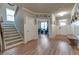 Bright foyer with hardwood floors, stairs leading upstairs, and views into the office at 592 Eagles Nest Cir, Auburn, GA 30011