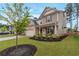 Lovely two-story home with manicured lawn, dark mulch flowerbeds, and a covered front porch at 592 Eagles Nest Cir, Auburn, GA 30011