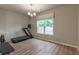 Workout area with a treadmill, bench, weights, and large window offering natural light at 592 Eagles Nest Cir, Auburn, GA 30011