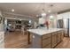 Well-lit open kitchen with a large central island and stainless steel appliances at 592 Eagles Nest Cir, Auburn, GA 30011