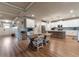 Open-concept kitchen with white cabinets, large island, stainless appliances, and wood flooring at 592 Eagles Nest Cir, Auburn, GA 30011