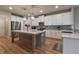 Bright, modern kitchen with white cabinets, a kitchen island, and stainless steel appliances at 592 Eagles Nest Cir, Auburn, GA 30011