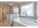 Elegant bathroom features a soaking tub and a separate glass shower at 592 Eagles Nest Cir, Auburn, GA 30011