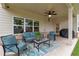 Covered patio with a ceiling fan, seating and grill, perfect for outdoor dining and relaxing at 592 Eagles Nest Cir, Auburn, GA 30011